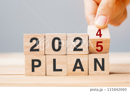 hand flipping block 2024 to 2025 PLAN text on table. Resolution, strategy, goal, motivation, reboot, business and New Year holiday concepts 115842093