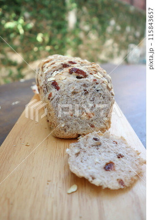 bread , whole wheat bread or sourdough bread or loaf of bread or cranberry and whole grain bread in the tray 115843657
