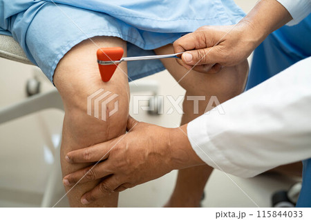 Doctor neurologist testing reflex knee with hammer and show Asian senior scars surgical total knee joint replacement. Doctor neurologist testing reflex knee with hammer and show Asian senior scars surgical total knee joint replacement. 115844033