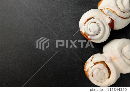 Fragrant Cinnabons with cream on a gray background 115844320