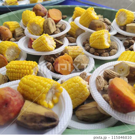A dessert dish at an event consisting of boiled corn, boiled keledek, and boiled banana served on a plastic plate. A dessert dish at an event consisting of boiled corn, boiled keledek, and boiled banana served on a plastic plate. 115846810
