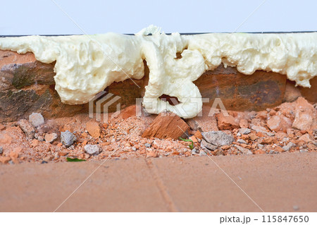 Construction foam. Installation of a metal plastic window,door,brick wall.  115847650