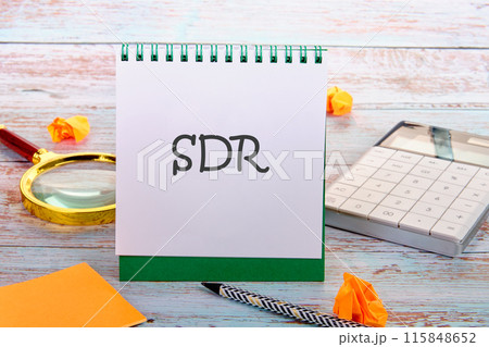 Business concept. SDR Special Drawing Rights acronym in an upright notebook in a composition with office supplies 115848652