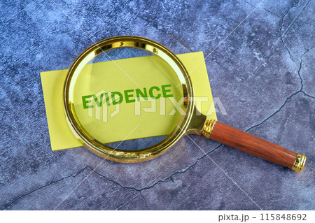 Business and finance concept. The inscription - EVIDENCE through a magnifying glass to a yellow business card lying on a blue abstract background Business and finance concept. The inscription - EVIDENCE through a magnifying glass to a yellow business card lying on a blue abstract background 115848692