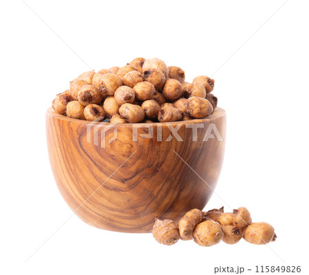 Tiger nuts in wooden bowl, isolated on white background. Pile of chufa nuts, earth almond or chufa sedge. Cyperus esculentus. 115849826