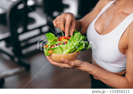 Healthy women in Fitness Gym Body Care by Eating Vegetable and weight Training in Sport Club. 115850211