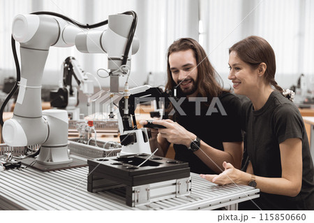 Industrial Robotics program university students learning education mechanical assembly with Robot Universal Training Platform robot arm simulation model in engineering lab classroom. Industrial Robotics program university students learning education mechanical assembly with Robot Universal Training Platform robot arm simulation model in engineering lab classroom. 115850660