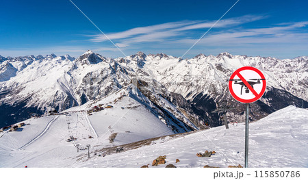 Panoramic view of winter snowy mountains and no fly zone sign. drone prohibition concept Panoramic view of winter snowy mountains and no fly zone sign. drone prohibition concept 115850786