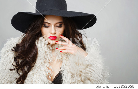 Elegance young adult woman fashion model with bright make-up and long wavy hair  115852059