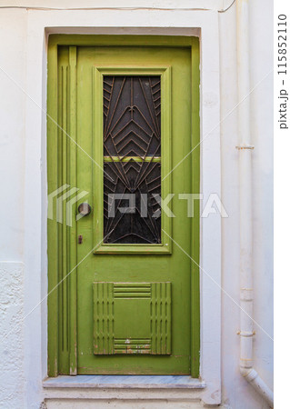 Green old door in Greece. Travel and architecture concept Green old door in Greece. Travel and architecture concept 115852110