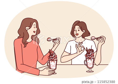 Women having lunch sitting in restaurant eating milkshake and discussing personal lives Women having lunch sitting in restaurant eating milkshake and discussing personal lives 115852380
