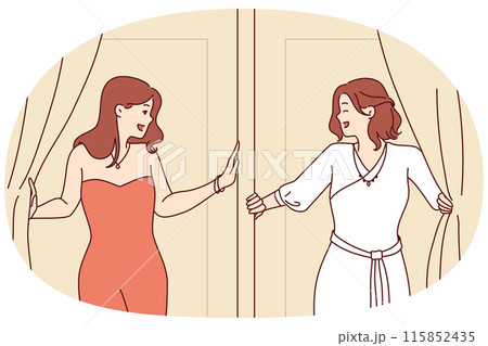Two women leave fitting room in elegant evening dresses for gala dinner or party 115852435