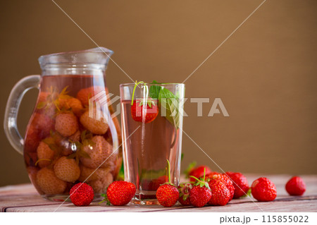 Sweet refreshing berry compote of ripe strawberries in a decanter 115855022
