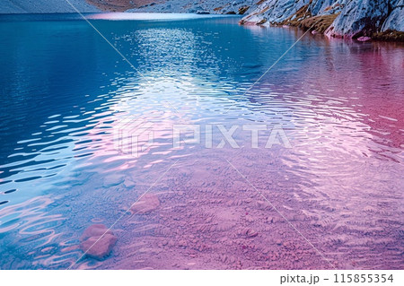 Serene Waterscape with Reflections of Mountains and Pink-Hued Sky at Sunset 115855354
