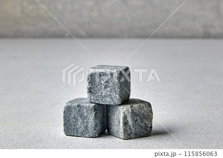 Three stone cubes on a gray concrete pillar. Mockup for presentation and sale of goods 115856063