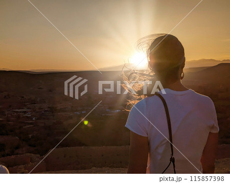 A female tourist watching the sunset over the historic village of Ait Ben Haddou A female tourist watching the sunset over the historic village of Ait Ben Haddou 115857398