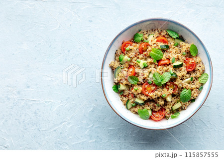 Quinoa tabbouleh salad in a bowl, a healthy dinner with tomatoes and mint Quinoa tabbouleh salad in a bowl, a healthy dinner with tomatoes and mint 115857555