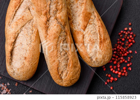 Crispy mini baguette with seeds and grains, salt and spices 115858923