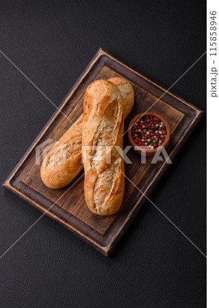 Crispy mini baguette with seeds and grains, salt and spices Crispy mini baguette with seeds and grains, salt and spices 115858946