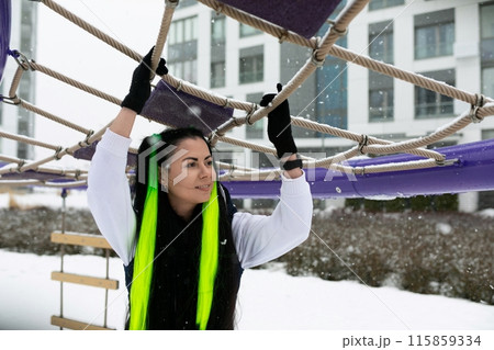 Woman Holding Onto Rope in Snow Woman Holding Onto Rope in Snow 115859334