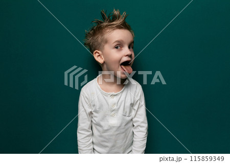 Young Boy Making Funny Face With Tongue Out 115859349