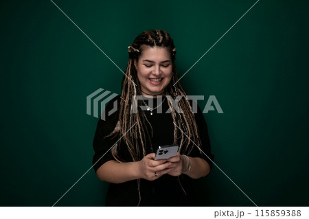 Woman With Dreadlocks Holding Cell Phone Woman With Dreadlocks Holding Cell Phone 115859388