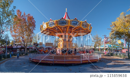 Oktoberfest. Carnival rides and games are set up in the fairgrounds, and children and adults alike enjoy them. 115859638