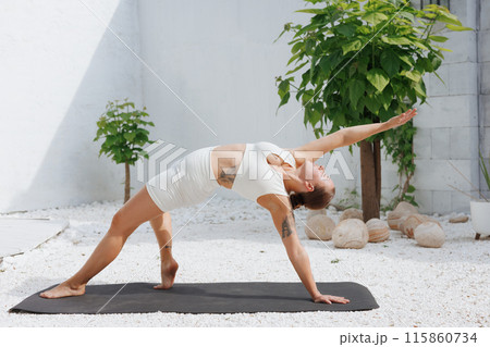 yoga stretching outdoors. side view of overweight woman practicing yoga on white background, body care concept 115860734