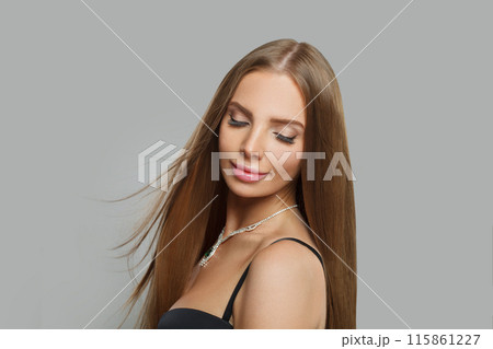 Healthy woman with makeup wearing jewelry necklace with sapphire and diamond on grey background 115861227