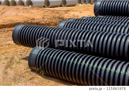 Flowing rainwater into main collecting container using plastic black pipes 115861978