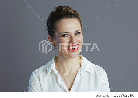 smiling elegant 40 years old woman worker isolated on gray 115862590