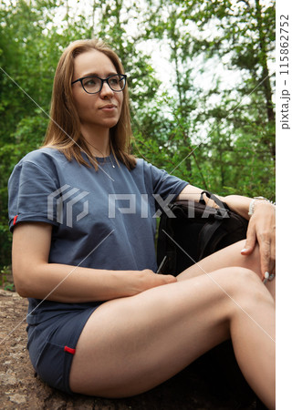 woman walking early in summer forest area 115862752