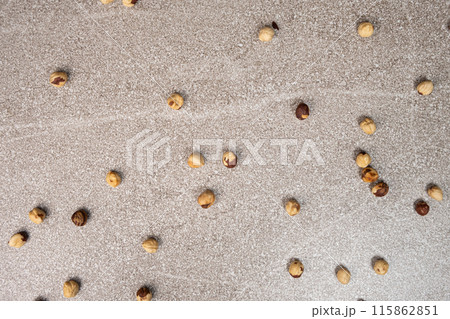 Roasted hazelnuts on a gray stone background top view. 115862851