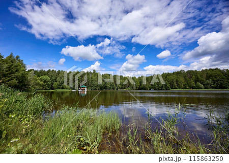 Beautiful summer river at sunny day with clouds reflection in the water Beautiful summer river at sunny day with clouds reflection in the water 115863250