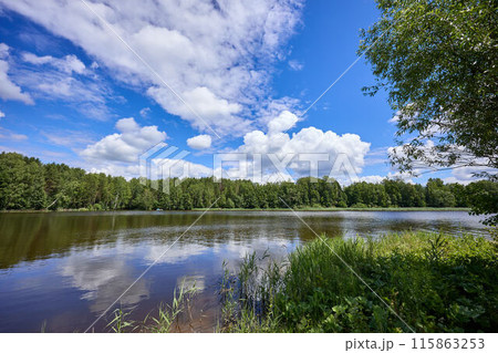 Beautiful summer river at sunny day with clouds reflection in the water 115863253