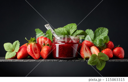 Strawberry jam and fresh berries on a black background. 115863315