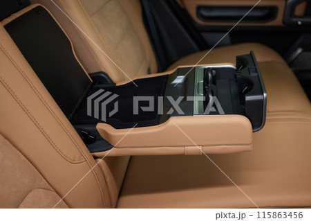 Luxury car back seat with open arm rest in sleek hardwood design Luxury car back seat with open arm rest in sleek hardwood design 115863456