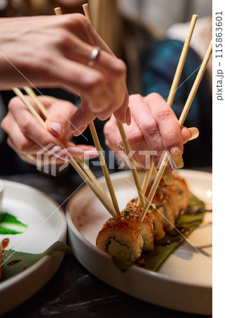 Sushi dish on white plate with sauce, table setting Sushi dish on white plate with sauce, table setting 115863601