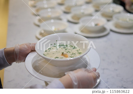 The caterers carefully arranged white bowls in preparation for the event service 115863622
