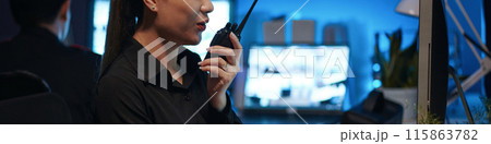 Woman Talking By Radio In Security Post Woman Talking By Radio In Security Post 115863782