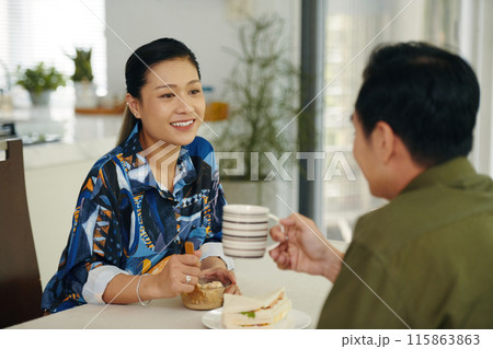 Couple Enjoying Breakfast Together At Home Couple Enjoying Breakfast Together At Home 115863863