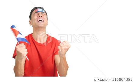 Man cheering for Cuba screaming and waving a national flag Man cheering for Cuba screaming and waving a national flag 115864383