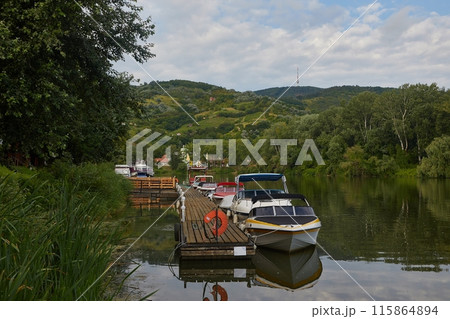 Lakeside pier with boats 115864894