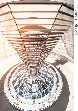 The intricate metal spiral ramp leading upwards inside the modern glass dome of the Reichstag Building, under a soft light. Berlin, Germany 115865322