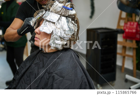 Hair coloring process at a professional beauty salon Hair coloring process at a professional beauty salon 115865766