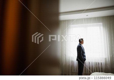 Beautiful man, groom posing and preparing for wedding Beautiful man, groom posing and preparing for wedding 115866049
