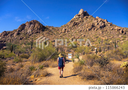 Tourist with a straw hat hiking to Pinnacle Peak near Phoenix, Arizona Tourist with a straw hat hiking to Pinnacle Peak near Phoenix, Arizona 115866243