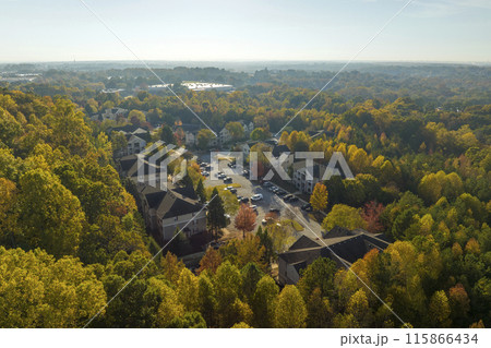 View from above of apartment residential condos between yellow fall trees in suburban area in South Carolina. American homes as example of real estate development in US suburbs 115866434