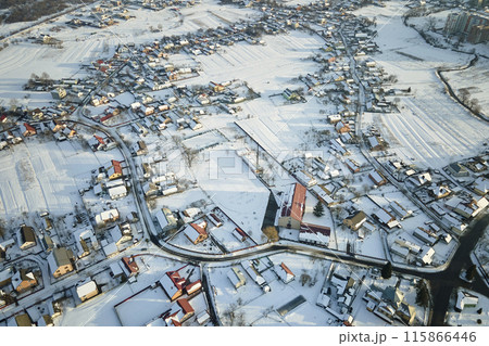 Aerial view of residential houses with snow covered roofops in suburban rural town area in winter 115866446
