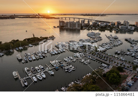 Aerial view of Sarasota city downtown at sunset with bay marina yachts and high-rise office buildings. Real estate development in Florida. USA travel destination 115866481